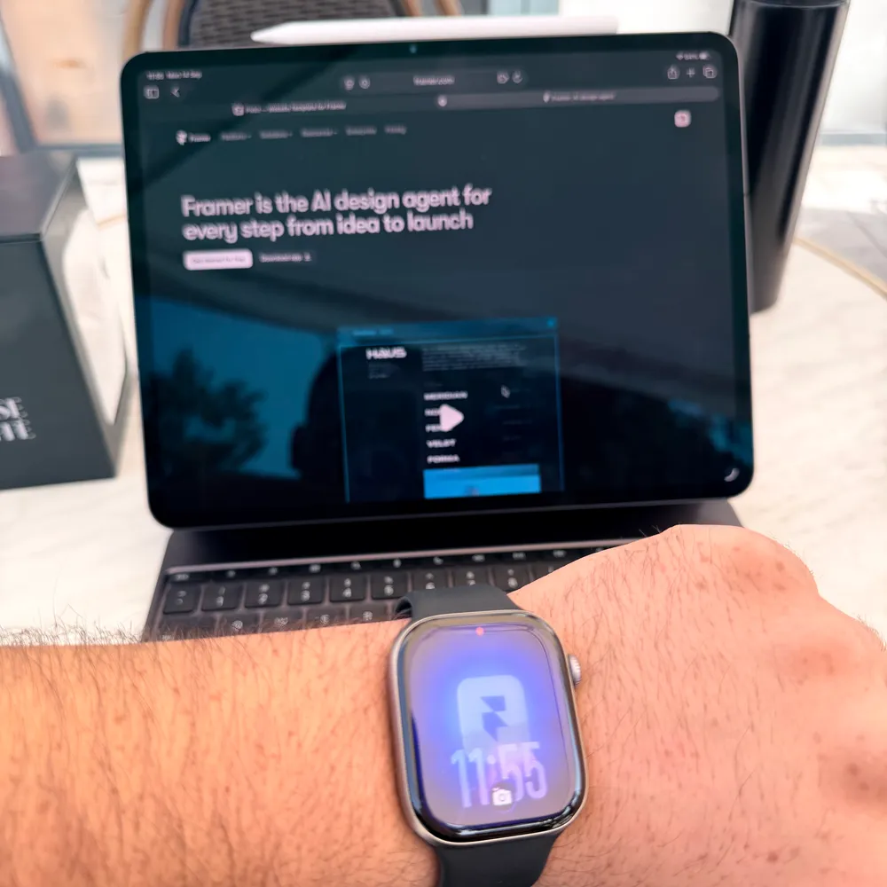 An Apple Watch with a Framer watch face in front of an iPad showing framer.com